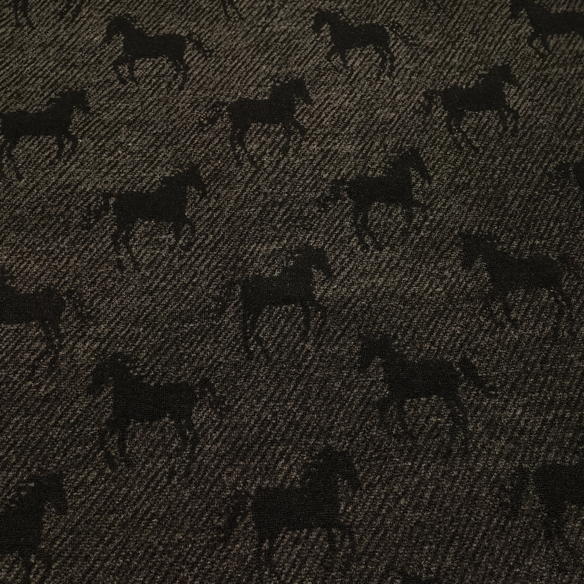Pattern of black horses on fabric