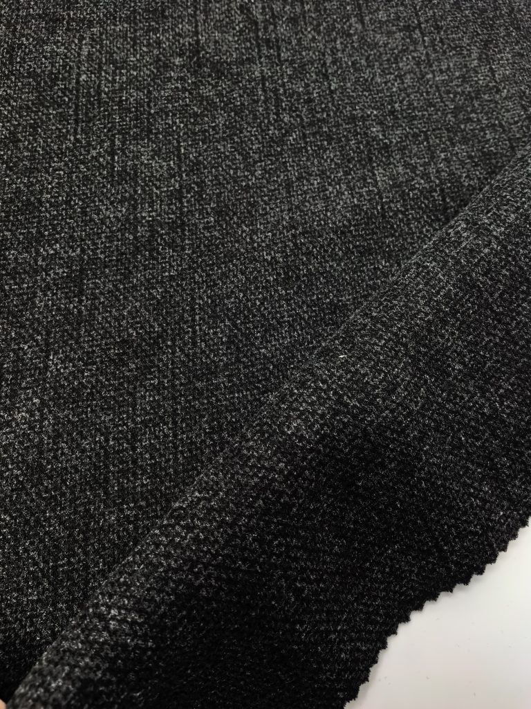 Micro Waffle Jacquard with Vertical Rain-Streak Mélange — Style 25048 Textured black fabric close-up.